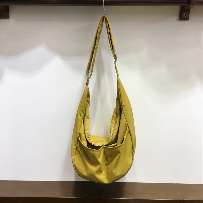 小脏柜 夏日韩系休闲男女简约通勤大容量单肩斜挎尼龙帆布饺子包