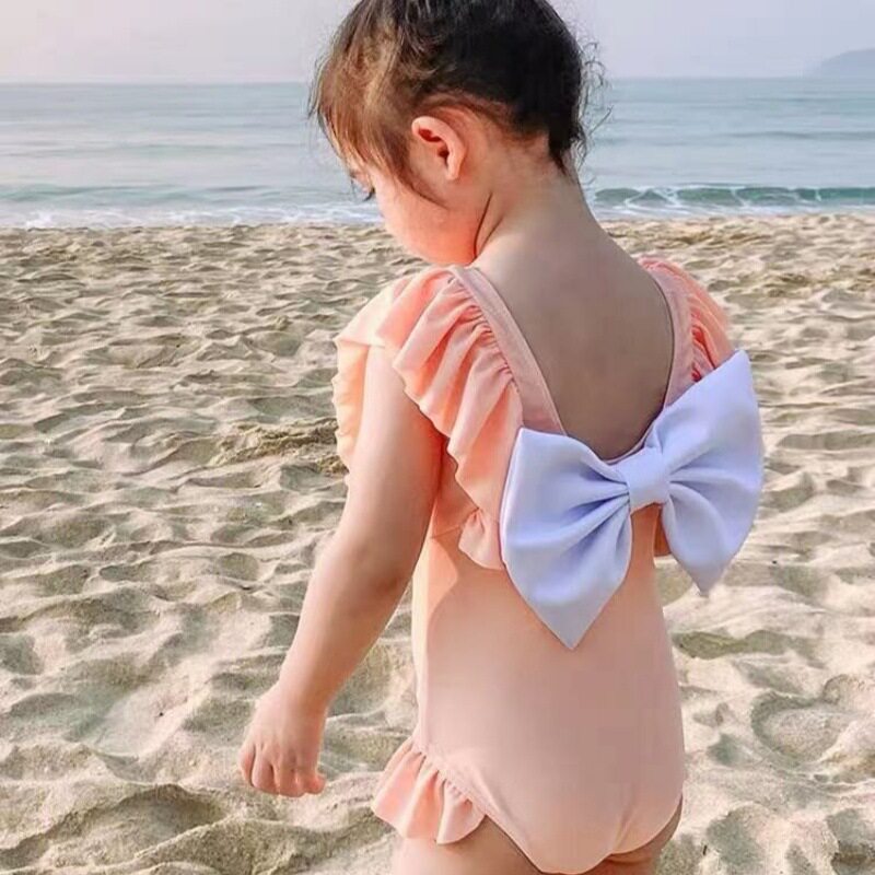 2025新款女童游泳衣儿童连体纯色蝴蝶结宝宝泳衣韩国可爱花边泳装