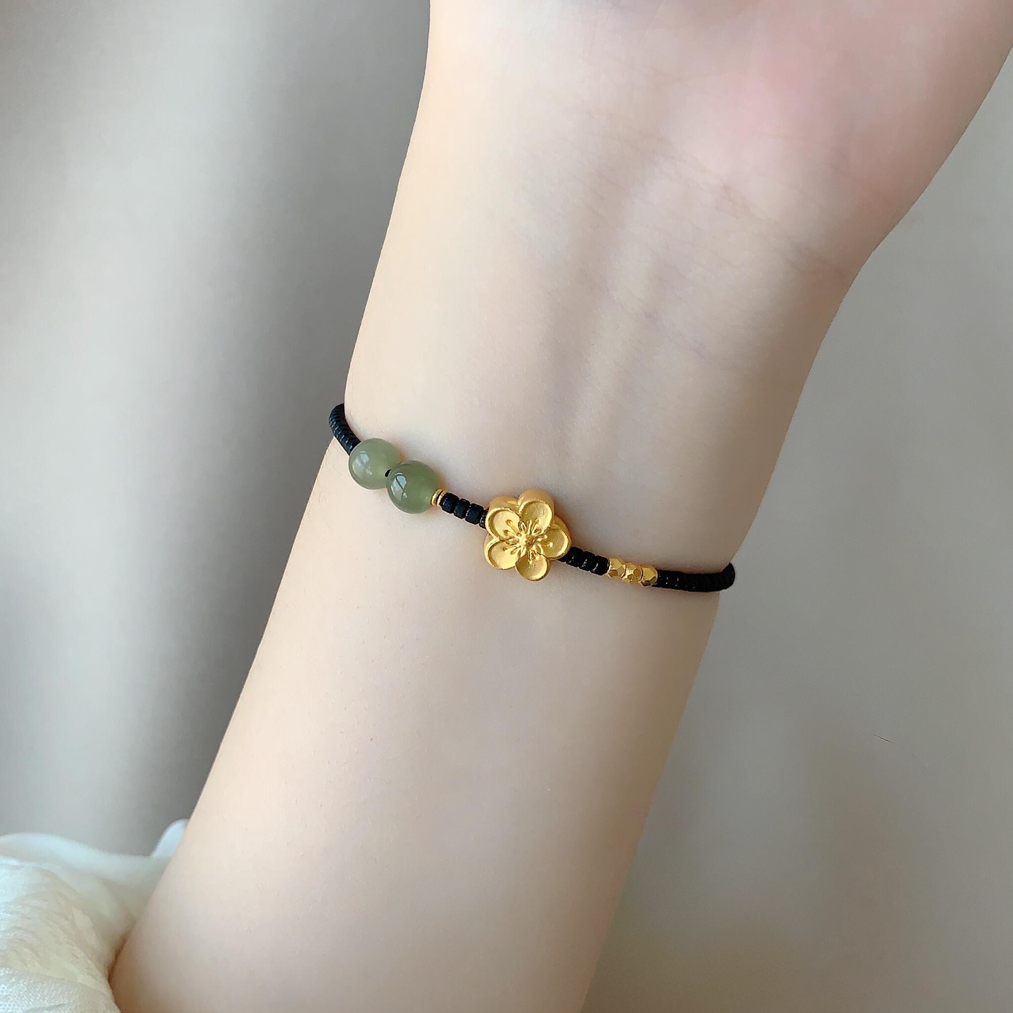 S925纯银金色桃花黑绳编织手链女图片