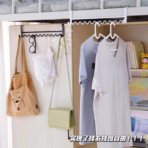 A useful item for hanging clothes by the bed in a dormitory: