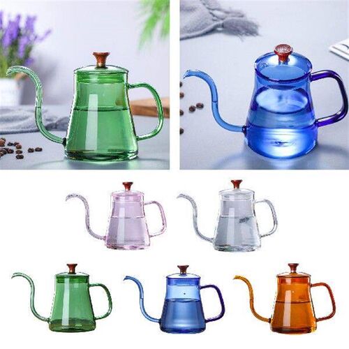 Glass of tea pouring over premium grade kettle with lid for