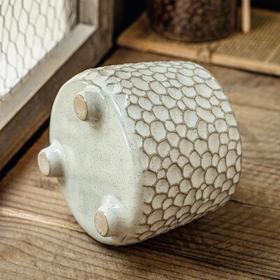 Pinecone-shaped three-legged ceramic storage jar and kitchen