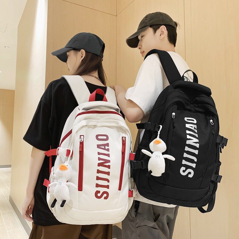 新款双肩背包女初高中大学生书包大容量休闲情侣款带挂件旅行双背图片