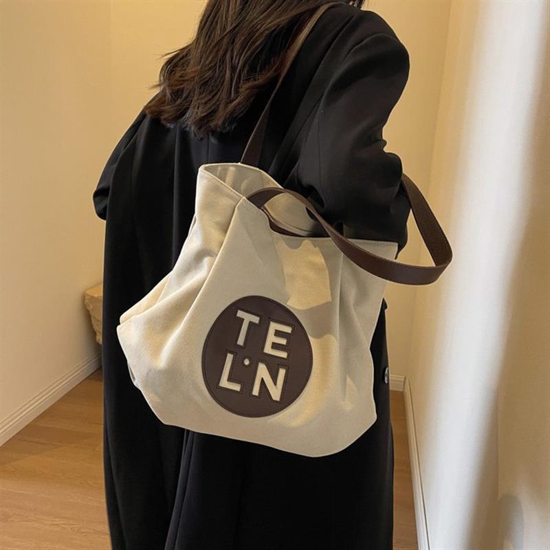 休闲黑色帆布包女单肩手提袋复古托特包大学生质感硬挺帆布袋日常
