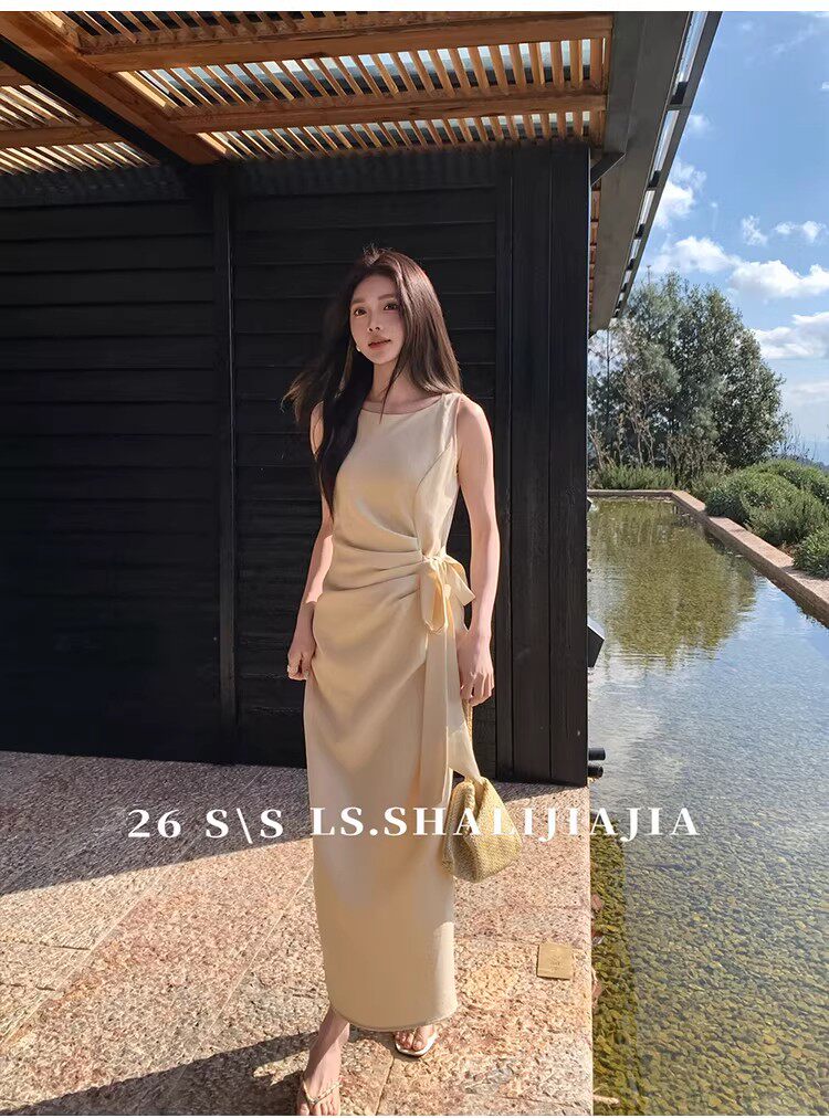Beige sleeveless long dress worn by a model outdoors