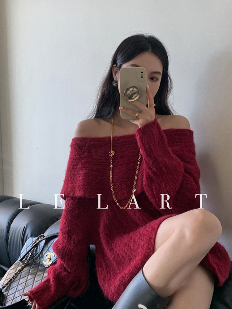 Model wearing an oversized burgundy off-shoulder fuzzy sweater