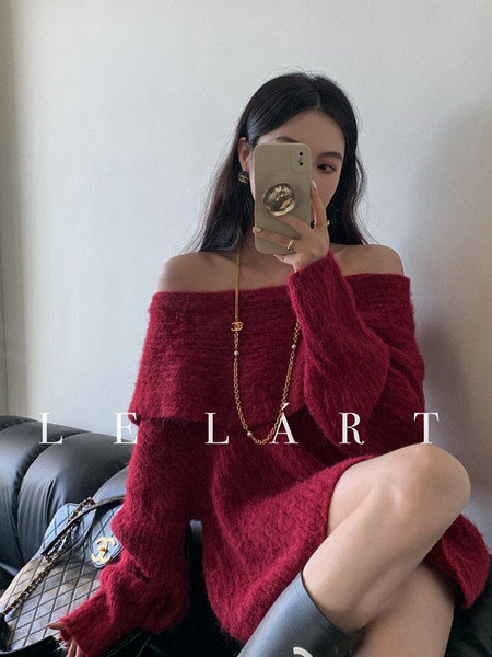 Model wearing an oversized burgundy off-shoulder fuzzy sweater