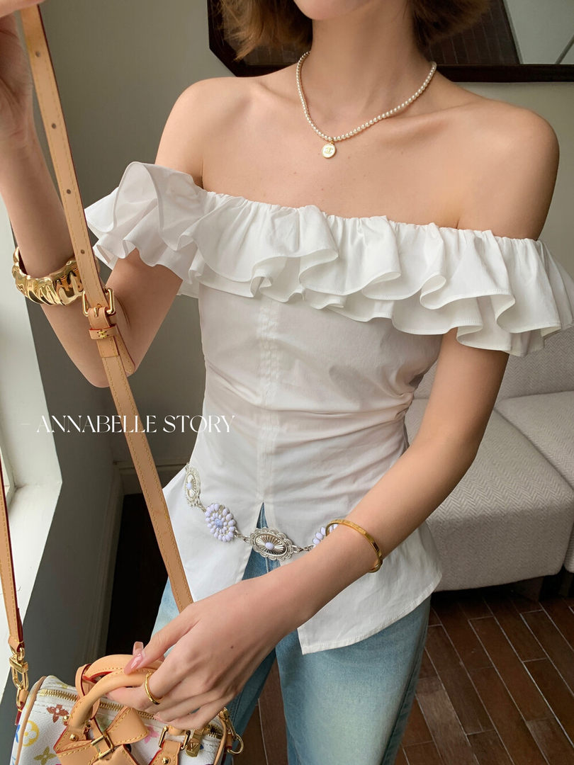 White off-shoulder ruffled top worn by a model