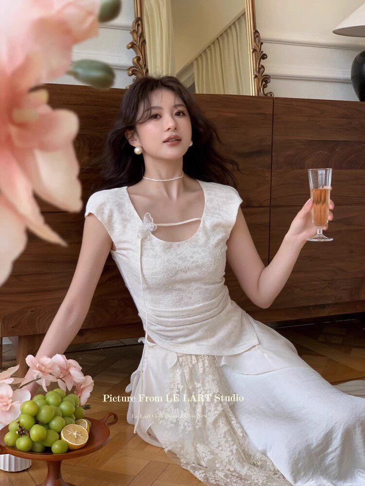 Woman wearing a white elegant dress with a textured design and lace detail