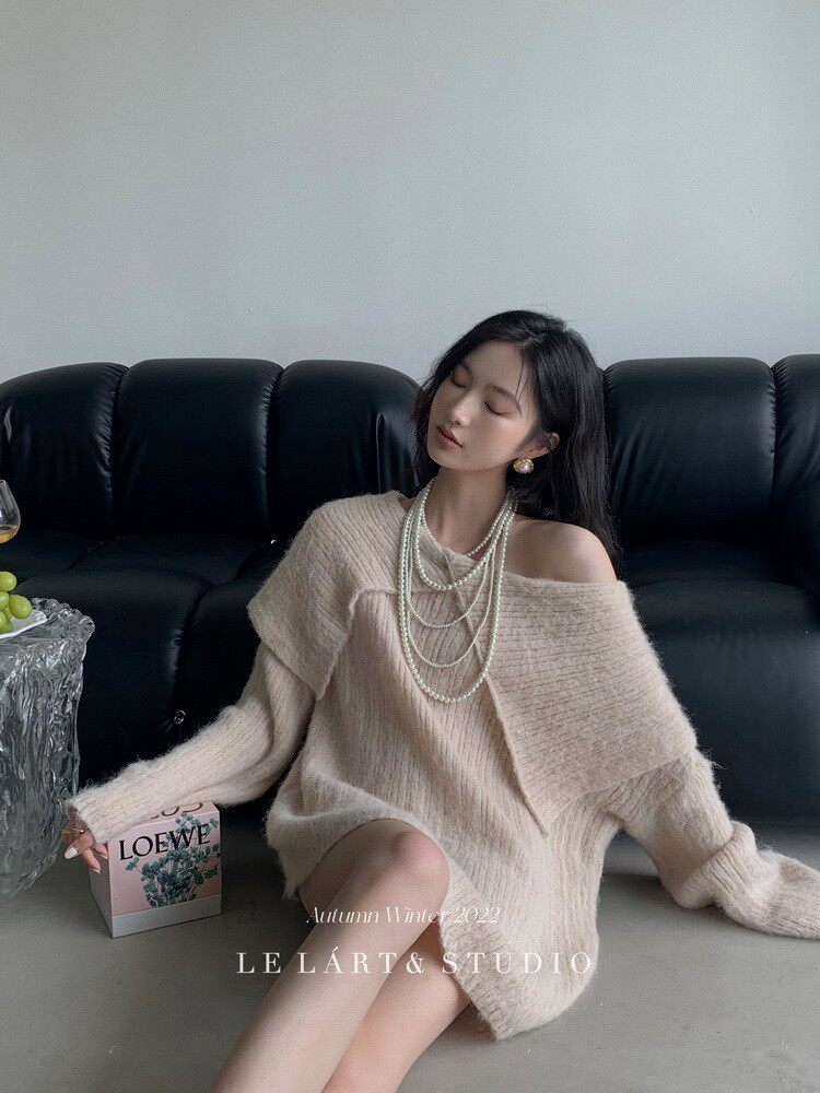 Woman wearing a beige oversized fuzzy knit sweater dress