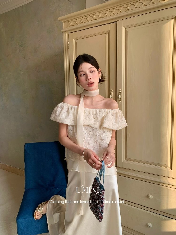 Off-white off-shoulder dress worn by a model