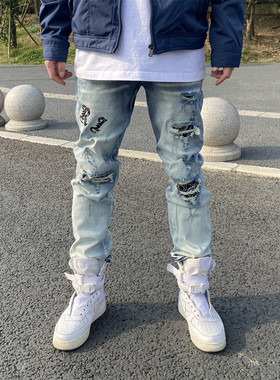 破洞刀割高街弹力修身小脚牛仔裤