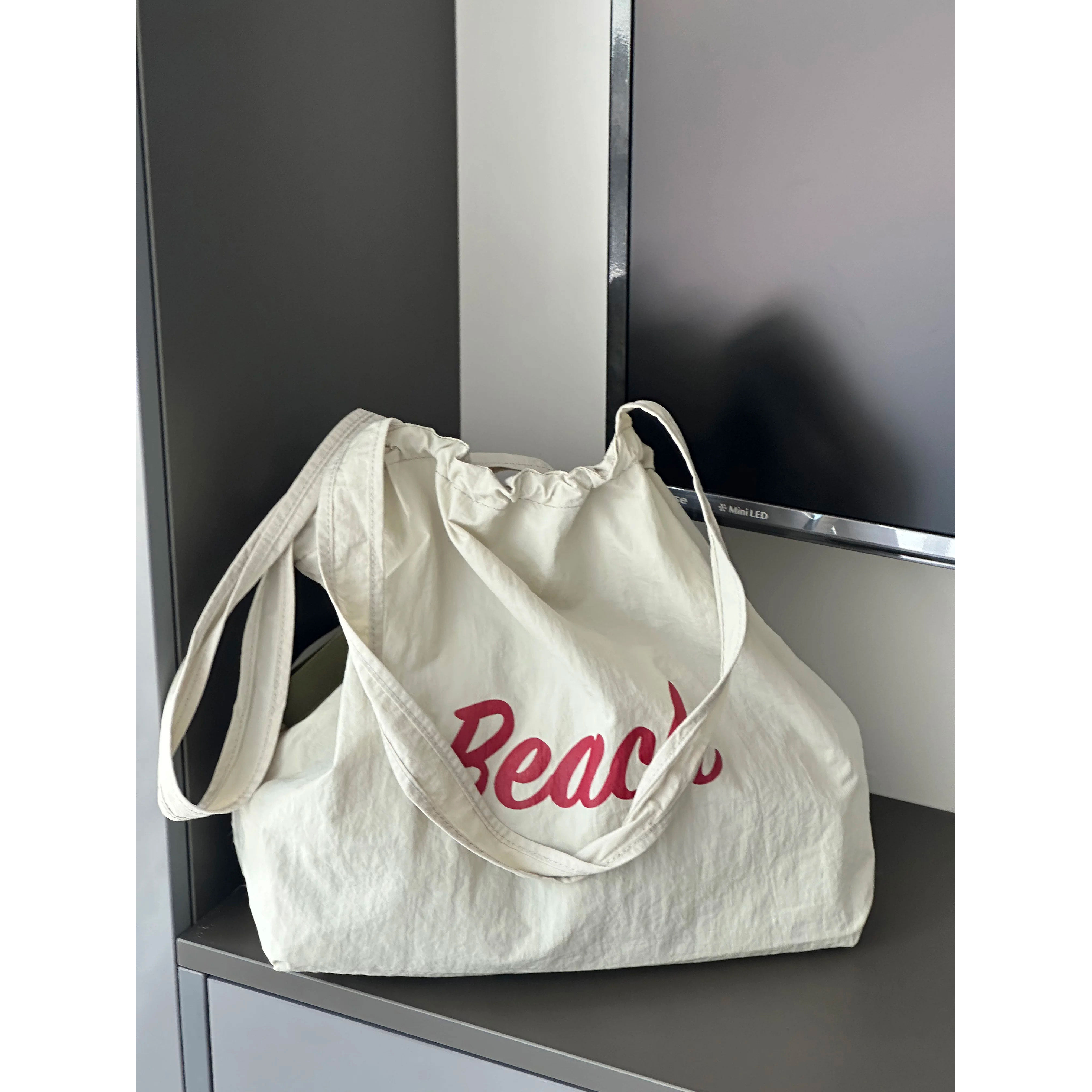 新款字母ins百搭慵懒风休闲帆布包大容量简约抽绳日系单肩托特包