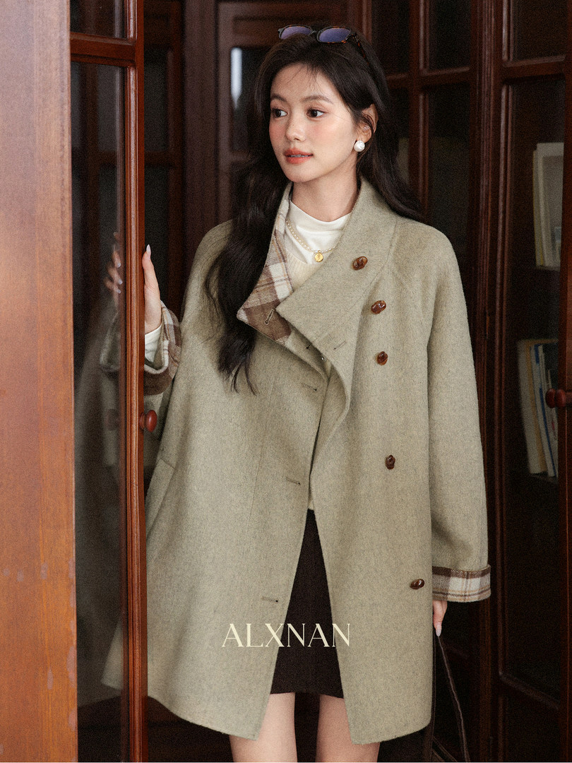 Woman wearing a light beige wool coat with plaid trim