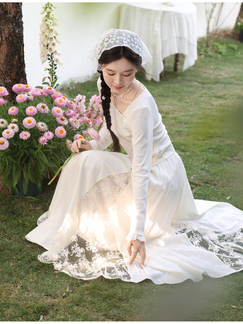 White lace long-sleeve dress worn by a woman outdoors