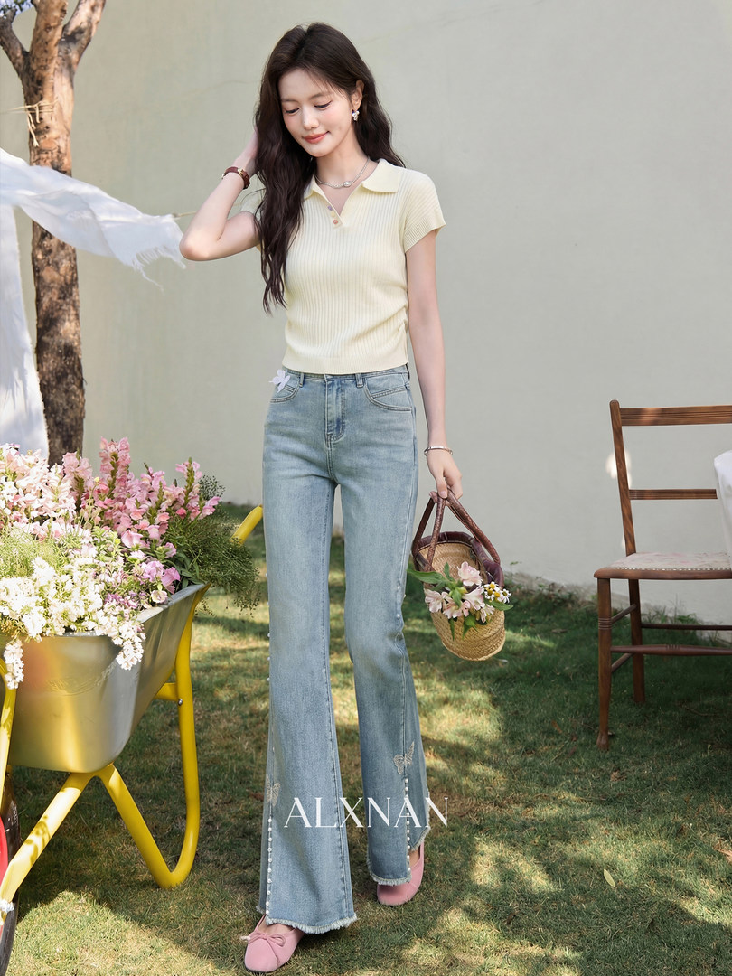 Model wearing a light yellow ribbed polo top with flared blue jeans and pink flats