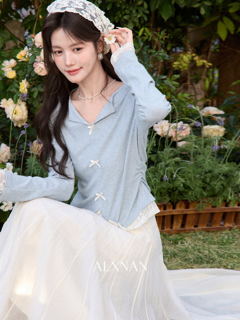Model wearing a light blue lace-trim top with a white tulle skirt and headband