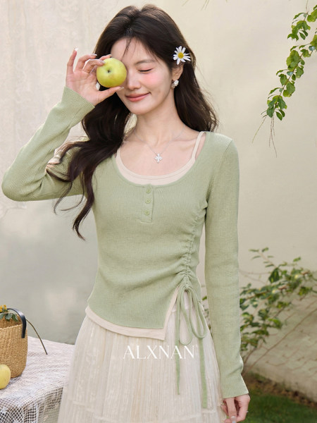 Model wearing a light green ribbed knit top with a cream tulle skirt