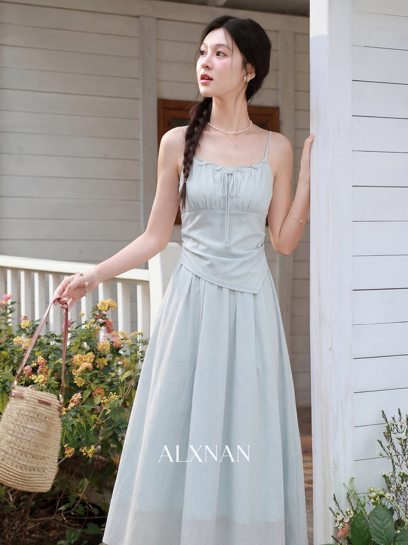 Light blue sleeveless maxi dress worn by a model outdoors
