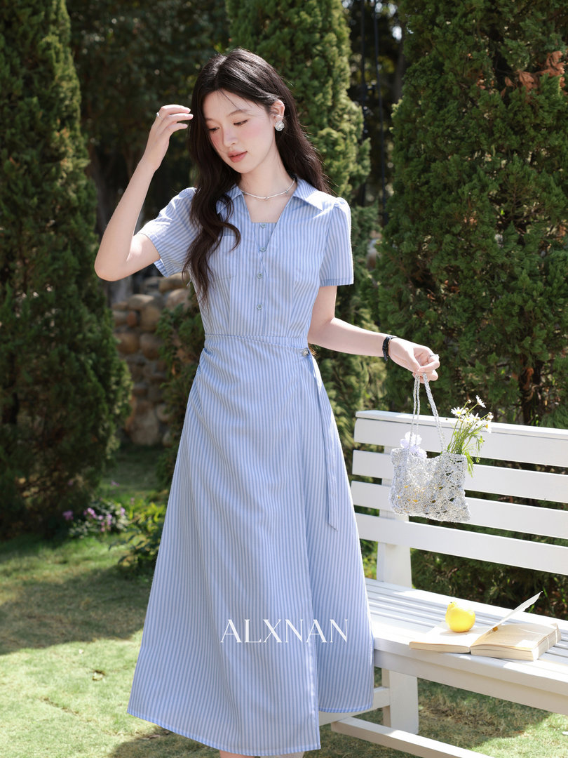 Light blue striped short-sleeve dress worn by a model outdoors