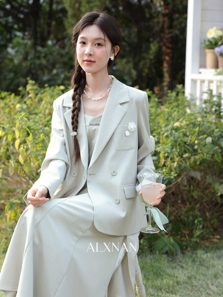 Light beige blazer and matching skirt set worn by a model outdoors