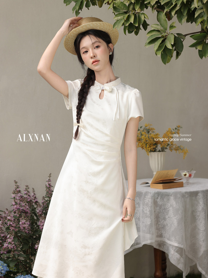 Model wearing a white elegant vintage-style dress