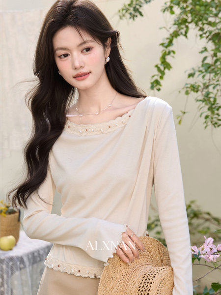 Woman modeling a cream long-sleeve lace-trim top