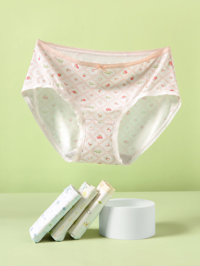 Pastel patterned women’s underwear briefs displayed on a green background
