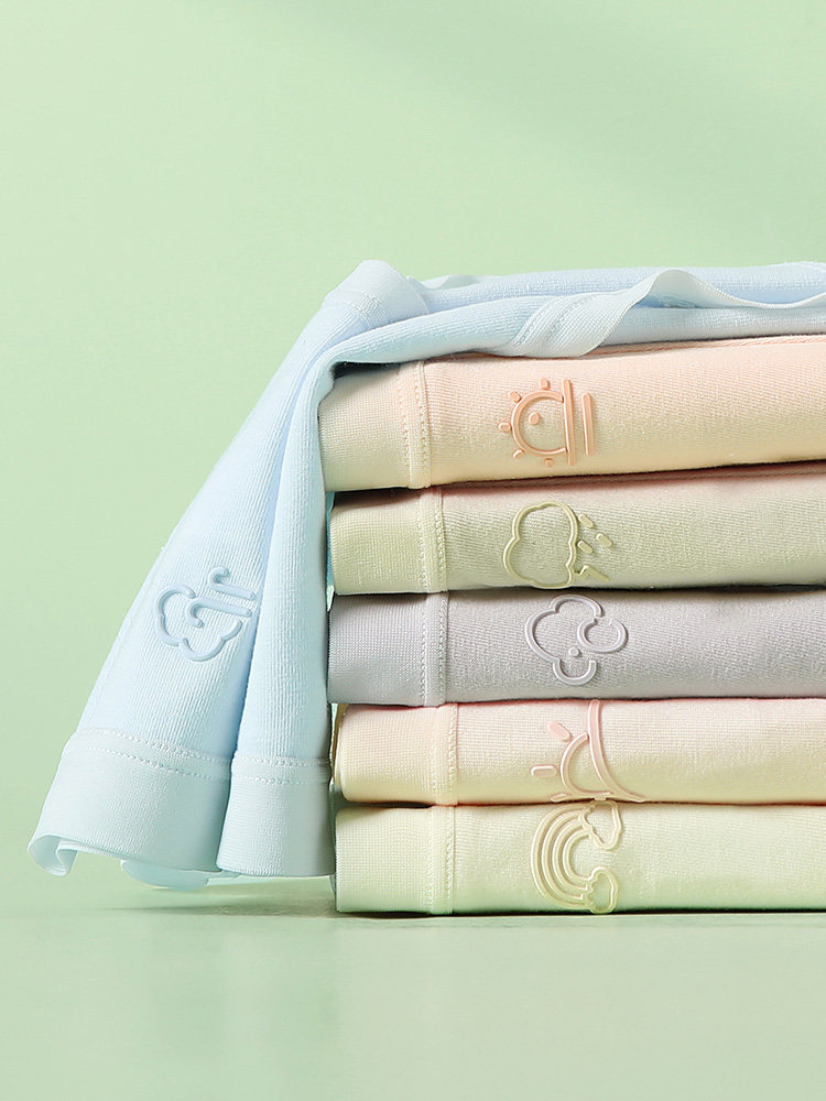 Stack of pastel folded long-sleeve shirts