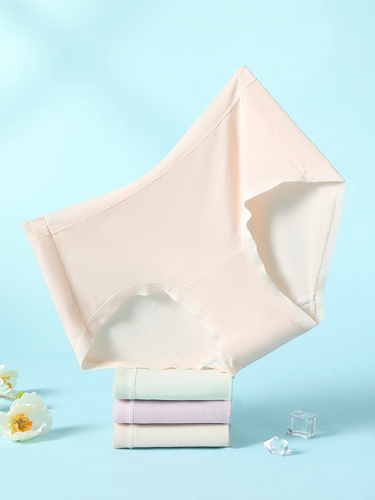 Light-colored seamless underwear briefs displayed on a blue background
