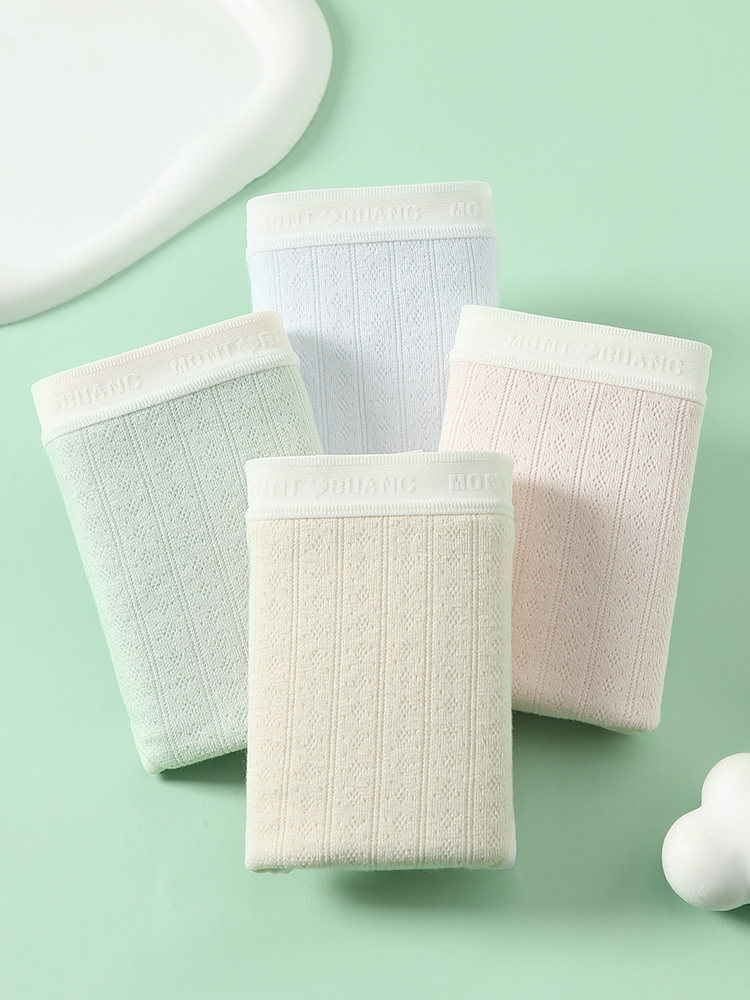 Four folded pastel ribbed underwear briefs displayed on a mint green background