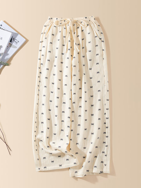 Cream lounge pants with black bow print laid flat