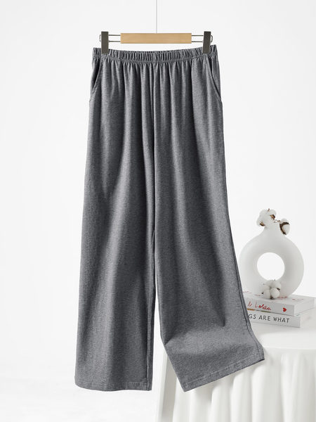 Gray wide-leg lounge pants hanging on a hanger against a white background