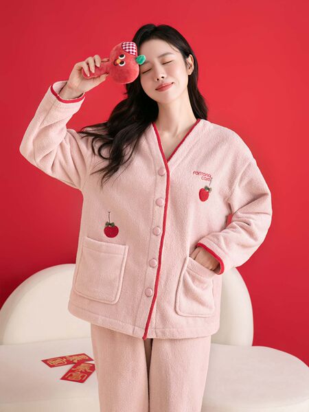 Pink cozy loungewear pajama set with strawberry details on a model