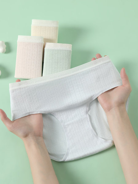 White ribbed underwear briefs displayed and held in hands
