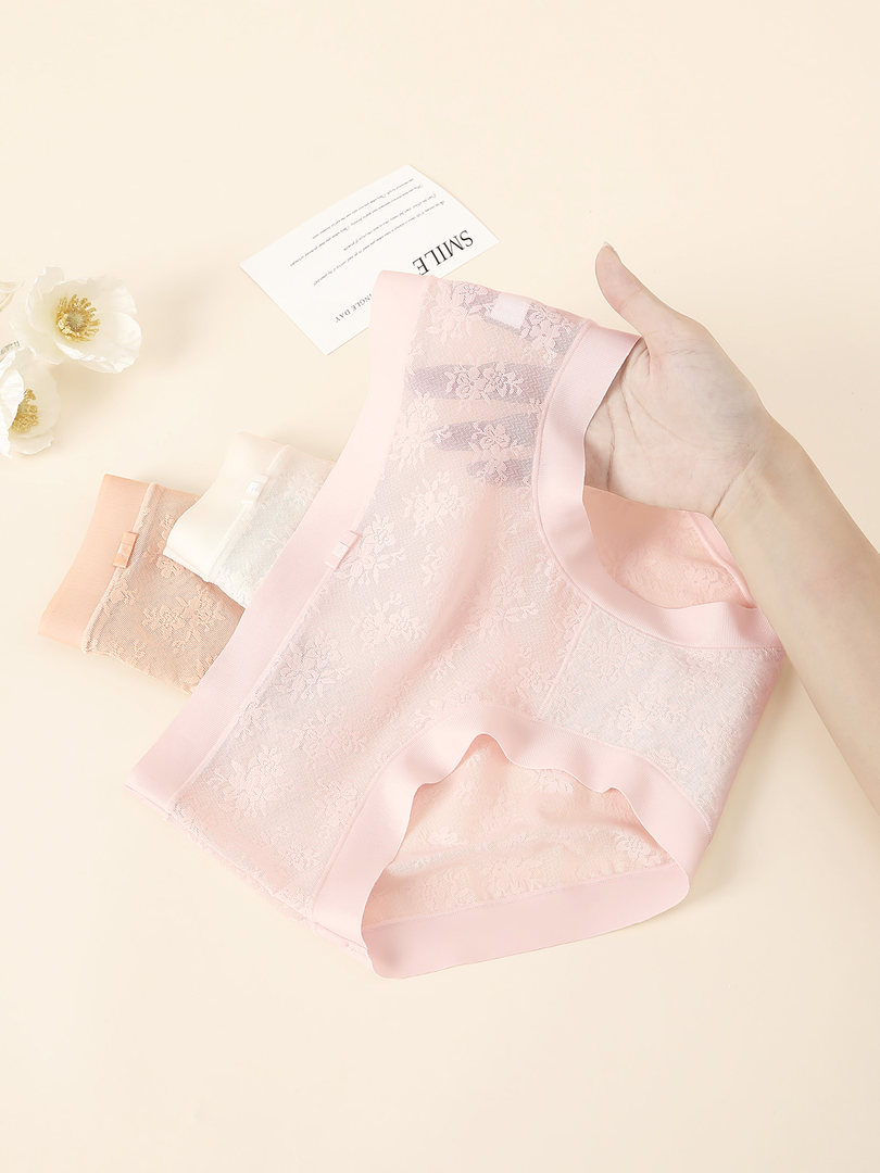 Pastel lace women’s underwear briefs laid flat on a light background