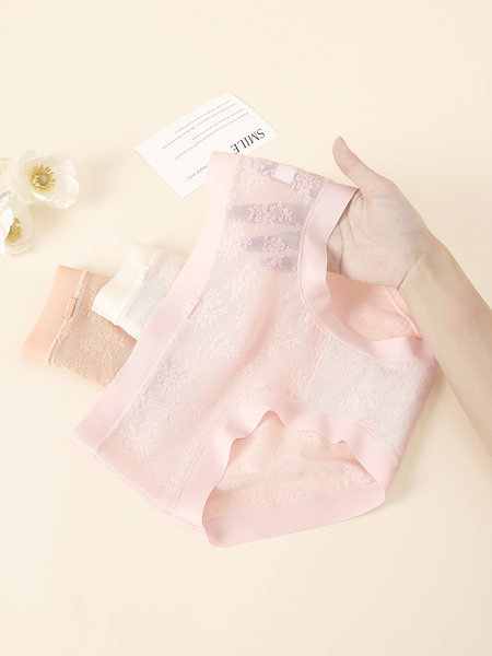 Pastel lace women’s underwear briefs laid flat on a light background