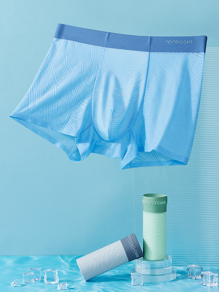 Blue men’s boxer briefs displayed on a light blue background