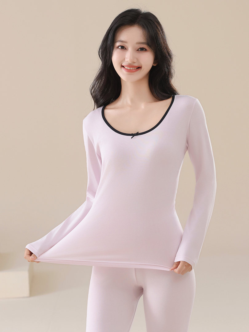 Model wearing a light pink long-sleeve top and matching leggings