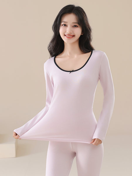 Model wearing a light pink long-sleeve top and matching leggings