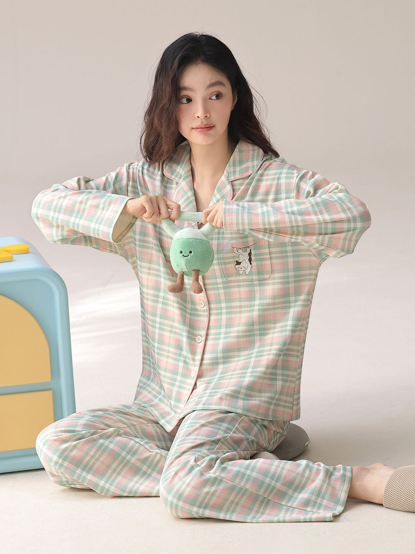 Model wearing pastel plaid pajama set with long sleeves and pants