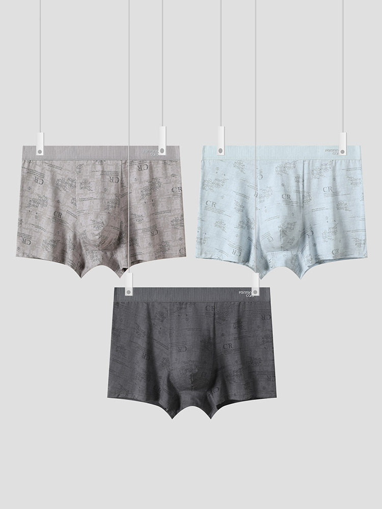 Three pairs of patterned boxer briefs hanging on clips