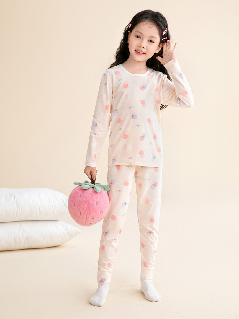 Child wearing a pastel printed long-sleeve pajama set