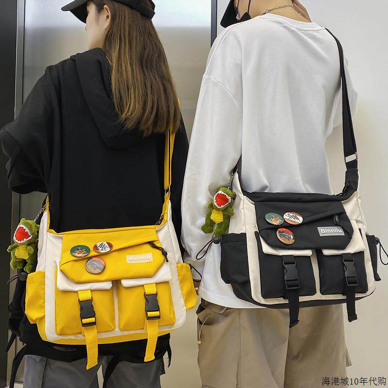 香港潮牌斜挎包男女帆布单肩包大容量学生情侣书包百搭休闲邮差包