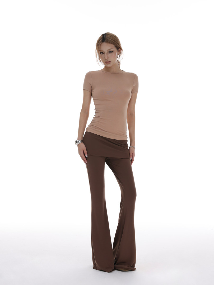 Model wearing a beige fitted short-sleeve top with brown flared pants