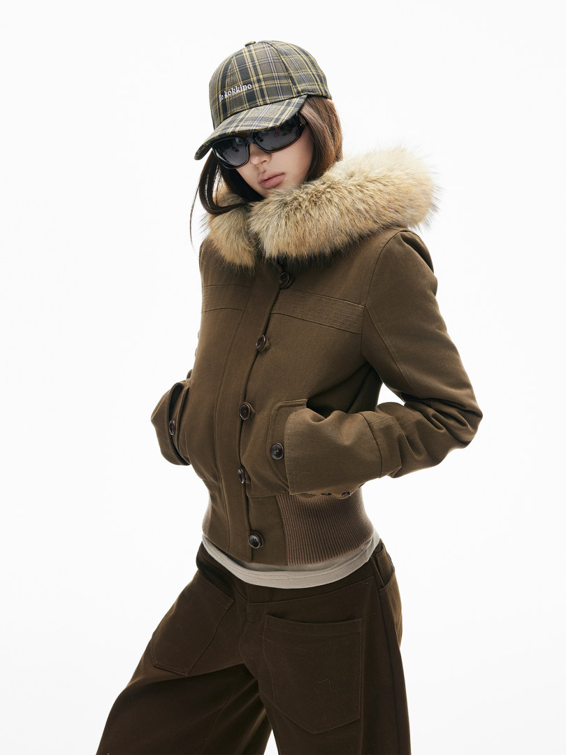 Brown winter jacket with fur-trim hood worn by a model