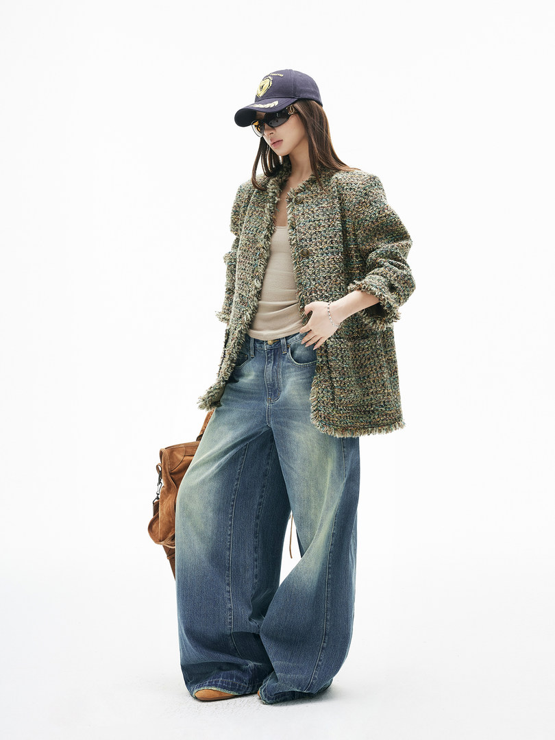 Fashion model wearing a tweed jacket, wide-leg jeans, cap, and sunglasses