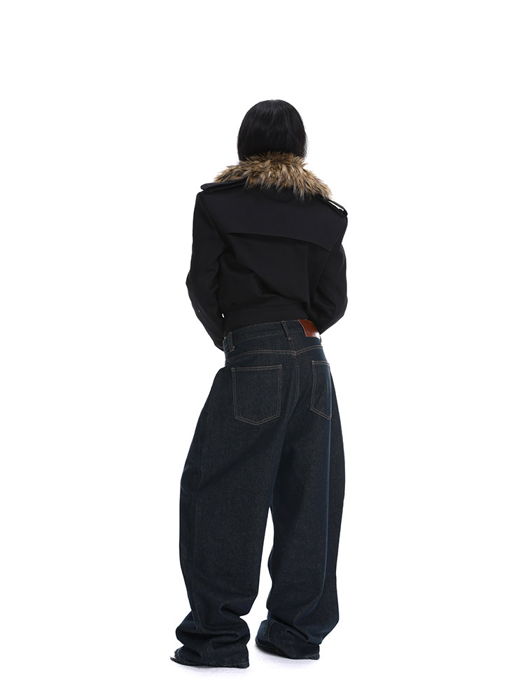 Model wearing a black jacket with a fur collar and dark oversized jeans