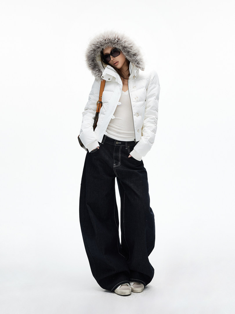Model wearing a white fur-hooded puffer jacket with black wide-leg jeans