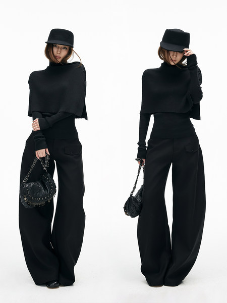Black fashion outfit worn by a model with wide-leg pants, turtleneck top, and hat